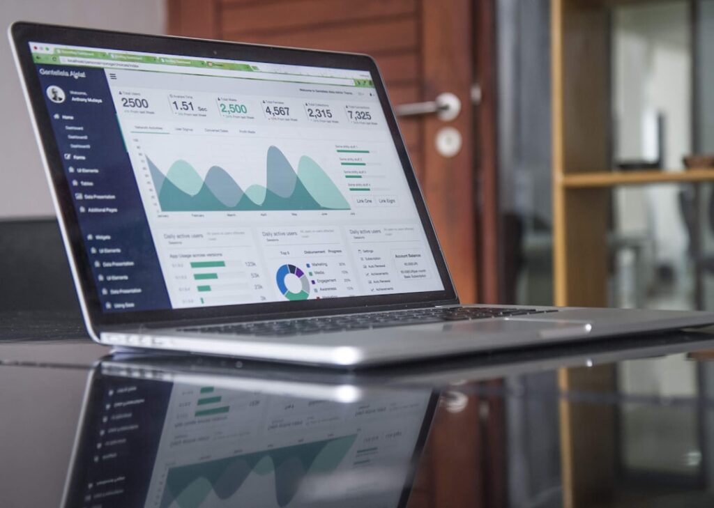 Laptop displaying financial statistics for investment account analysis