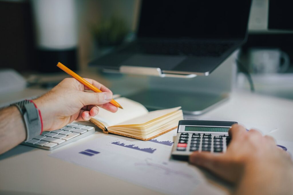 Calculator and financial documents representing debt-to-income ratio