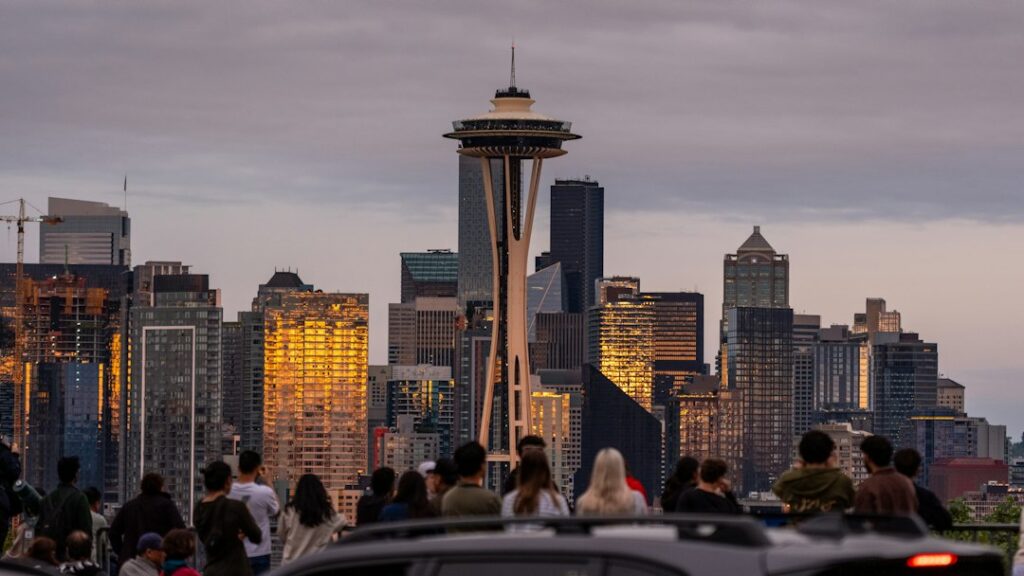 People viewing a city skyline representing economic output per person