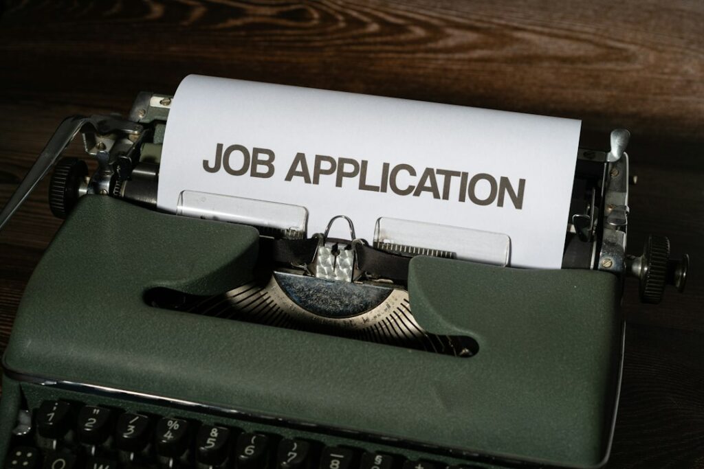 Job application paperwork representing unemployment claims and labor-market transitions