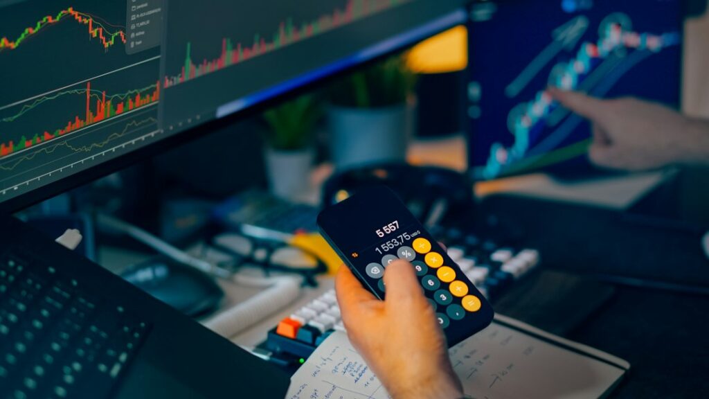 Investment analysis workstation with calculator representing fund fees
