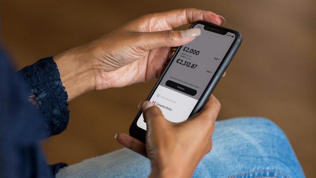 Hands using a smartphone banking app