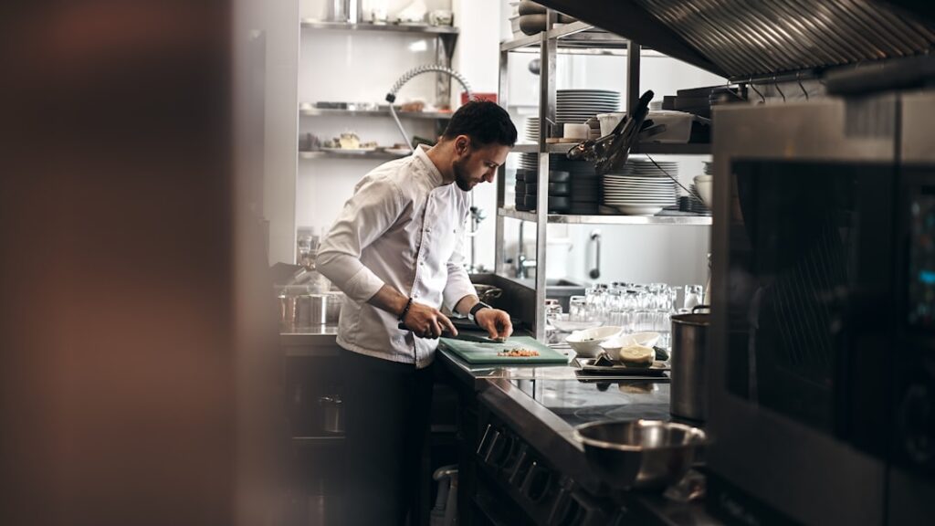 Chef working in a restaurant kitchen representing labor, food quality and operations